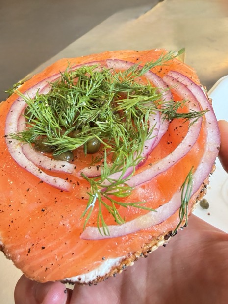 Bagel with lox, dill and red onion